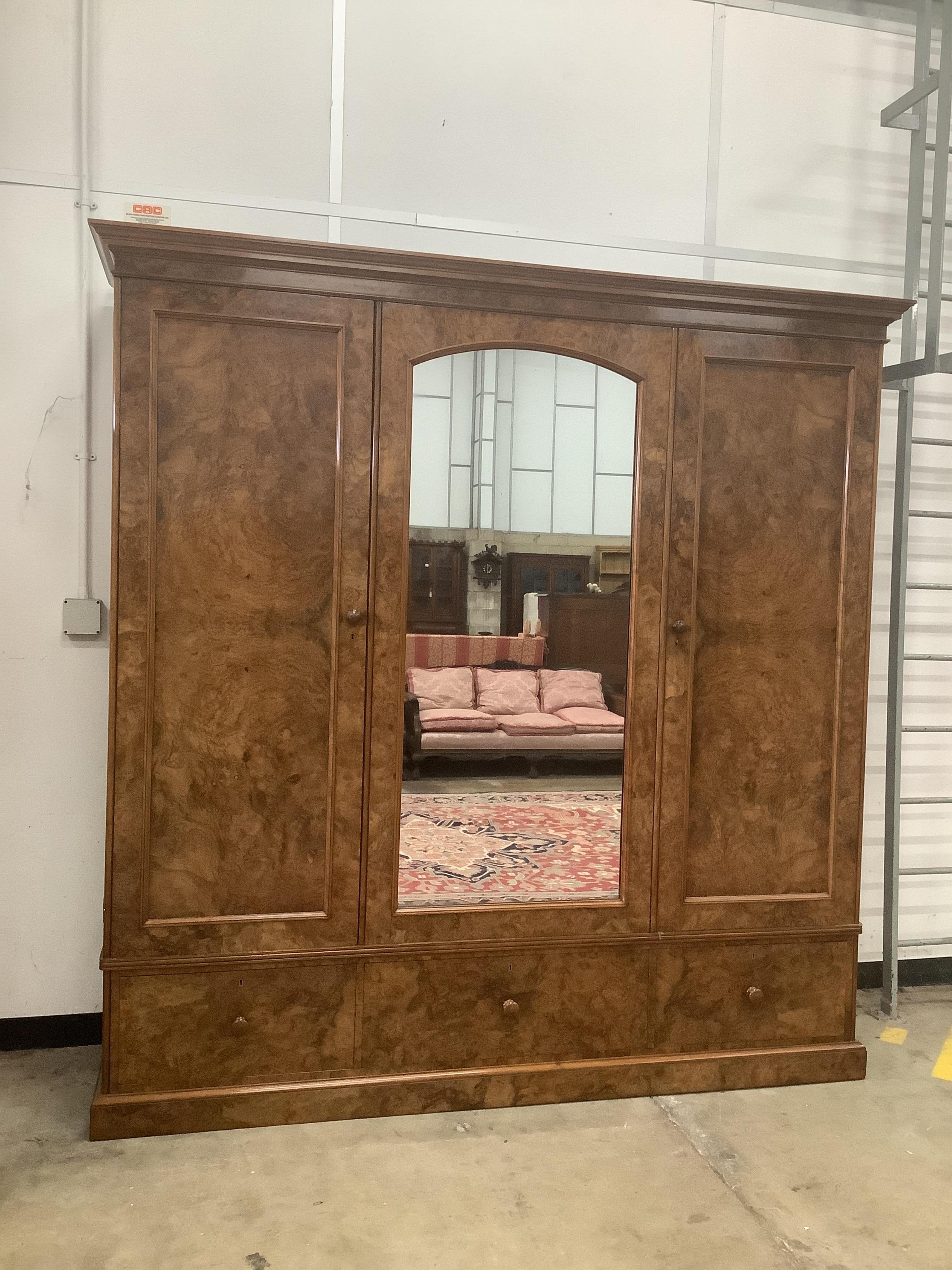 Holland & Sons, a Victorian burr walnut triple mirrored compactum wardrobe, width 225cm, depth 62cm, height 228cm. Condition - good